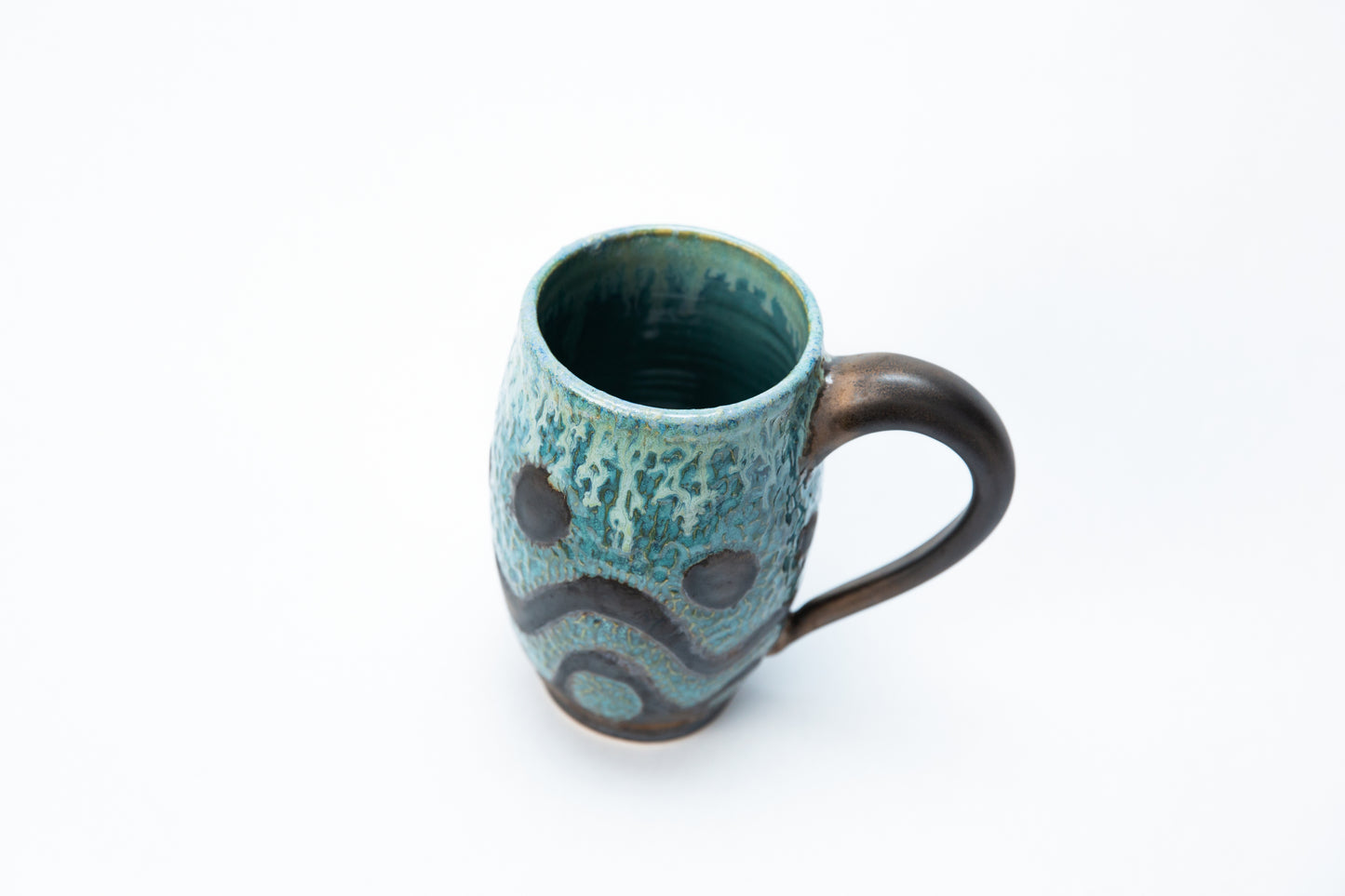 Tall Mug. Blue, Gun Metal, w/various glazes, Carved Wave Pattern.