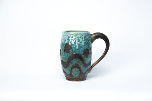 Tall Mug. Blue, Gun Metal, w/various glazes, Carved Wave Pattern.